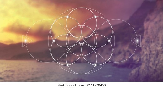 Flower of life - the interlocking circles ancient symbol in front of blurry photo background.