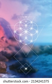 
Flower of life - the interlocking circles ancient symbol in front of blurry photo background.