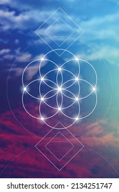 Flower of life - the interlocking circles ancient symbol in front of blurry photo background.