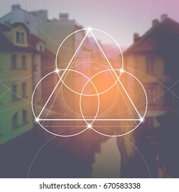 Flower of life - the interlocking circles ancient symbol in front of blurred photorealistic natural background. Sacred geometry - mathematics, nature, and spirituality, the formula of nature.