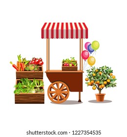 Flower stand on wheels. Brown cart with orange tree and houseplants. Balloons. Green leaves and exotic flowers in wooden boxes.