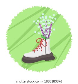 Flowers in a boot on a green round background. Spring.