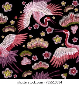 flowers cherry blossom and crane, east. traditional stylish fashionable embroidered embroidery on a black background. sketch for printing on fabric, bag, clothes, accessories and design. trend vector