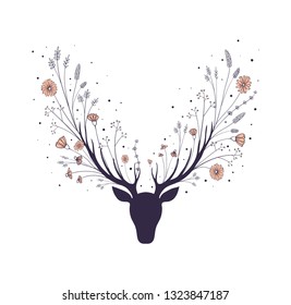 Flowers in the horns of a deer. Silhouette of the head of a forest animal.