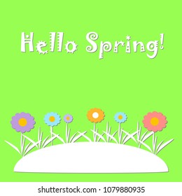 Flowers on green background with text Hello Spring and copy space.