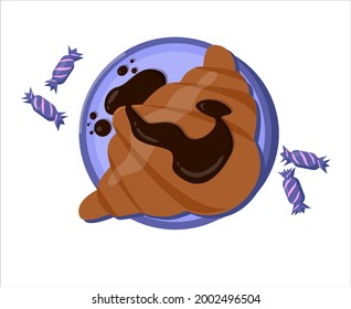a fluffy croissant just cooked, covered with chocolate on a plate next to there are colored candies