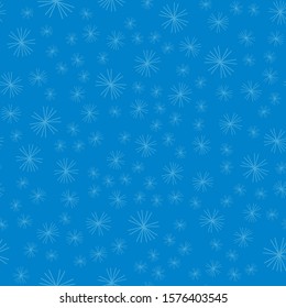 Fluffy snowflakes of small size arranged randomly on a blue background