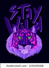 Fluorescent head of tiger with shiny green eyes, purple and pink fur, dark blue background. Hand drawn words STAY WILD behind.. Hand drawn vector illustration