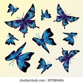 Fluttering black and blue butterflies on a light background