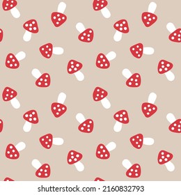 
Fly agaric mushrooms on a beige background. Naive seamless pattern of red caps and white dots. Cute nature baby print.