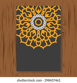 Flyer Oriental pattern on wood texture. Vector yellow mandala on black background.