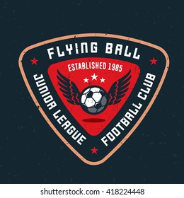 Flying Ball Varsity, College, School, Amateur League Football Soccer Sport Team Logo Concept, T Shirt Graphics. Jersey Apparel Design. Retro Old-Fashioned Distressed Textured Vector Illustration. 