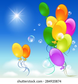 Flying balloons in the sky, sun and clouds