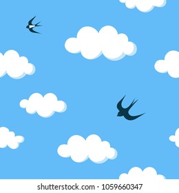 Flying barn swallows in the blue sky with white clouds seamless pattern