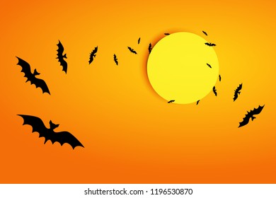 Flying bats on an orange background in the bright light of the moon. Halloween greeting card background