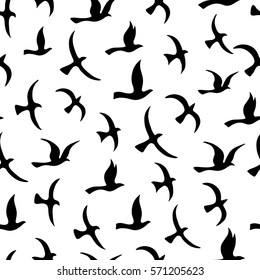 Flying birds seamless pattern.  Silhouette a flock. Vector illustration.