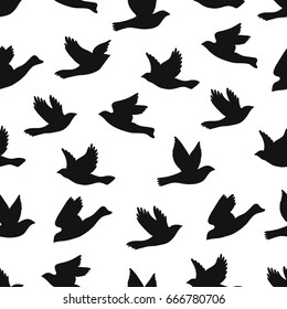Flying birds seamless pattern. Silhouette a flight of birds. Black and white endless background.