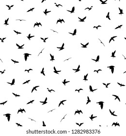 Flying birds silhouettes on white background. Animals seamless detailed pattern. Black on white backgound. Vector illustration