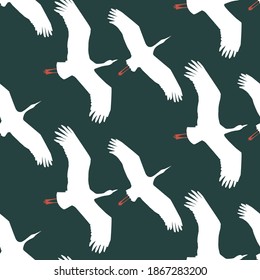 Flying cranes seamless pattern on deep green background