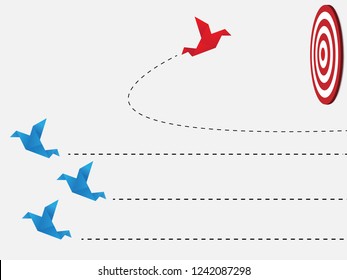 Flying origami. Red paper bird changing direction from blue. New ideas. Different business concepts. Courage to risk. leadership. Go to the goal of financial business success and effort go to target.