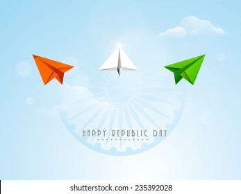 Flying paper plane in national tricolor with Ashoka Wheel on cloudy blue background for Indian Republic Day celebration.