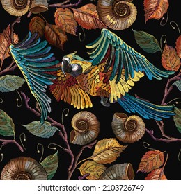 Flying parrot and autumn leaves. Seamless pattern. Fall garden art. Tropical style. Embroidery. Jungle birds. Template for clothes, t-shirt design 