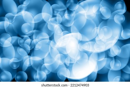 Flying transparent soap bubbles on dark background.