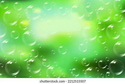 Flying transparent soap bubbles on defocused green background.