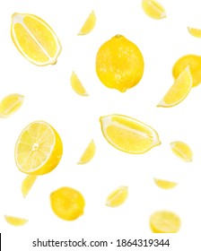 flying whole and sliced ​​lemons with blurred lemons in the background on a white background