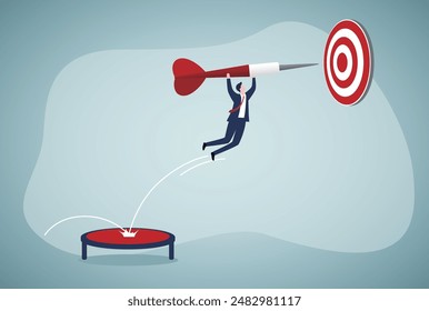 Focus on business goal, reaching target or achievement, achieve business objective or purpose, motivation to success concept, Businessman holding dart, bounce on trampoline jumping right to dartboard.