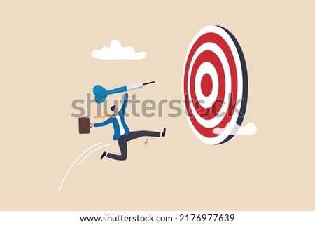 Focus on business goal, reaching target or achievement, achieve business objective or purpose, motivation to success concept, confidence businessman holding dart jumping right to dartboard bullseye.