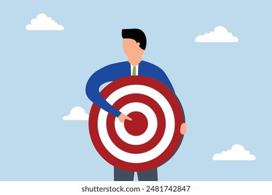 Focus on business target, businessman with archer target pointing at bullseye.