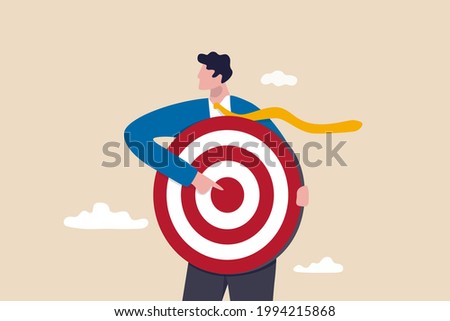 Focus on business target, setting goal for motivation, target audience for advertising or purpose for career development concept, businessman holding archer target or dashboard pointing at bullseye. ストックフォト © 