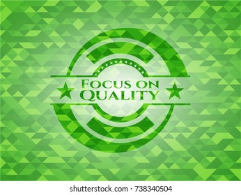 Focus on Quality green emblem with mosaic background
