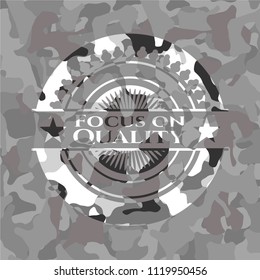 Focus on Quality on grey camouflaged pattern