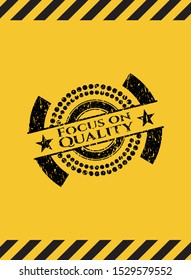 Focus on Quality grunge black emblem with yellow background, warning sign. Vector Illustration. Detailed.