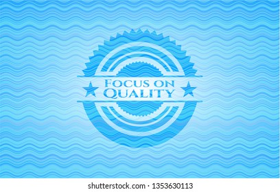Focus on Quality light blue water style emblem.