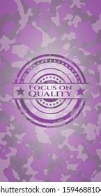 Focus on Quality pink written on a camouflage texture. Vector Illustration. Detailed.