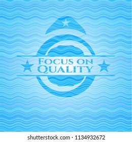 Focus on Quality water wave concept badge.
