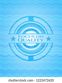 Focus on Quality water wave representation badge.