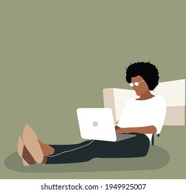 Focused black female using laptop at home, looking at screen, chatting, reading or writing email, sitting on couch, serious female student doing homework, working on research project online.