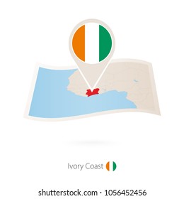 Folded paper map of Ivory Coast with flag pin of Ivory Coast. Vector Illustration