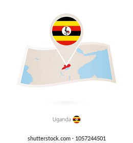 Folded paper map of Uganda with flag pin of Uganda. Vector Illustration