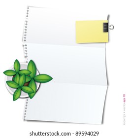 folded paper with tree on top and notepad
