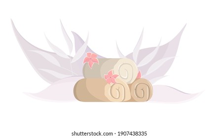 Folded towels with flowers on a background of purple leaves