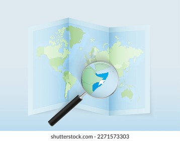 A folded world map with a magnifying lens pointing towards Somalia. Map and flag of Italy in loupe. Vector illustration in blue color tone.
