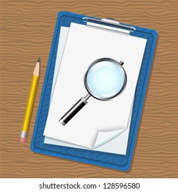 folder with clip and paper, magnifying glass and a pencil lying on a wooden table