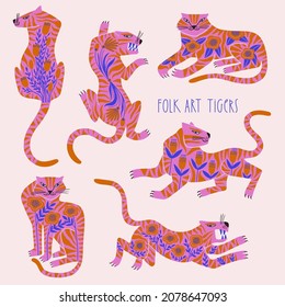 Folk art wild tigers decorated with flowers. Chinese New Year symbol. Set of isolated floral tiger illustrations.