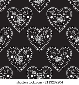 Folk flowers heart. Seamless pattern on the black background.