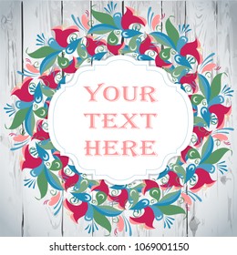 Folk wreath in a vintage rustic style with flowers and floristic elements on a wooden background, greeting card